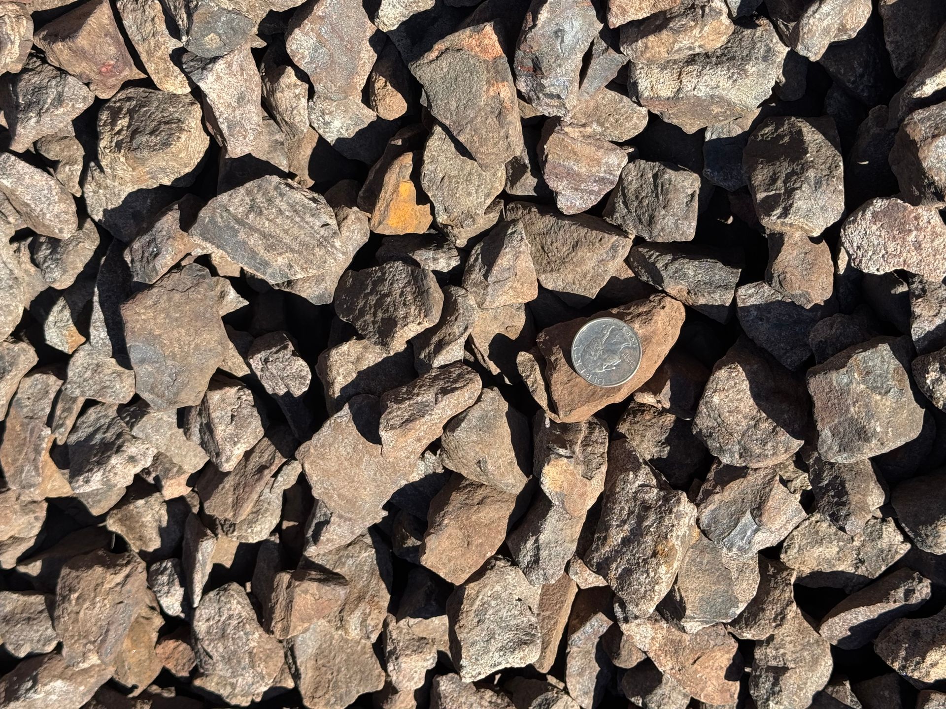 A pile of gravel is sitting on the ground.