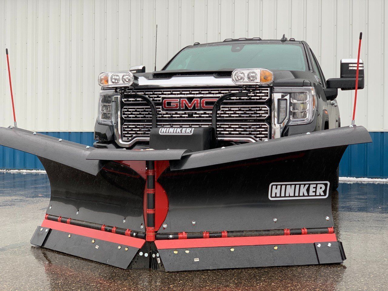 A gmc truck with a snow plow attached to it