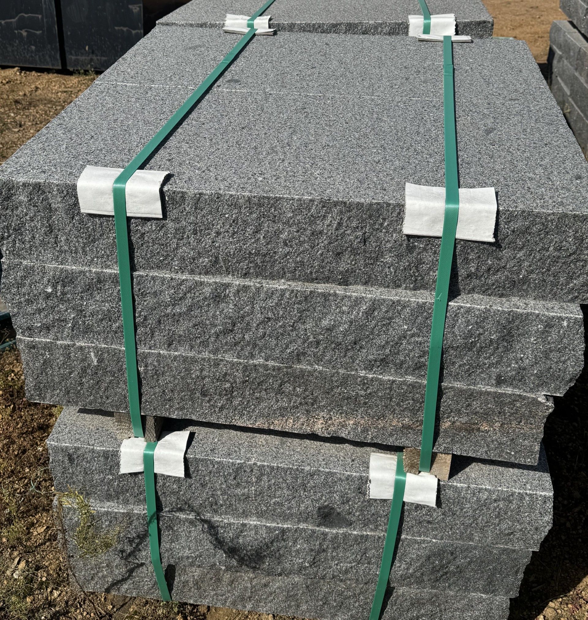 A stack of granite steps sitting on top of each other on a wooden pallet.