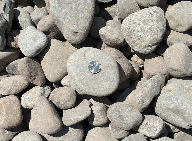 A pile of rocks with a coin in the middle