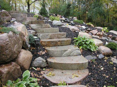 A set of stone stairs leading up to a rocky hillside.