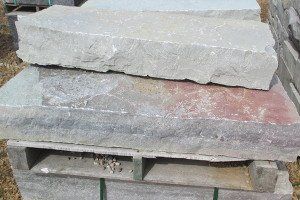 A pile of rocks stacked on top of each other on a wooden pallet.
