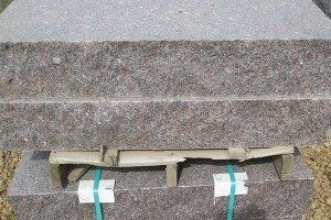 A piece of wood is sitting on top of a set of stairs.