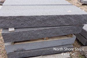 A stack of granite steps sitting on top of each other on a wooden pallet.