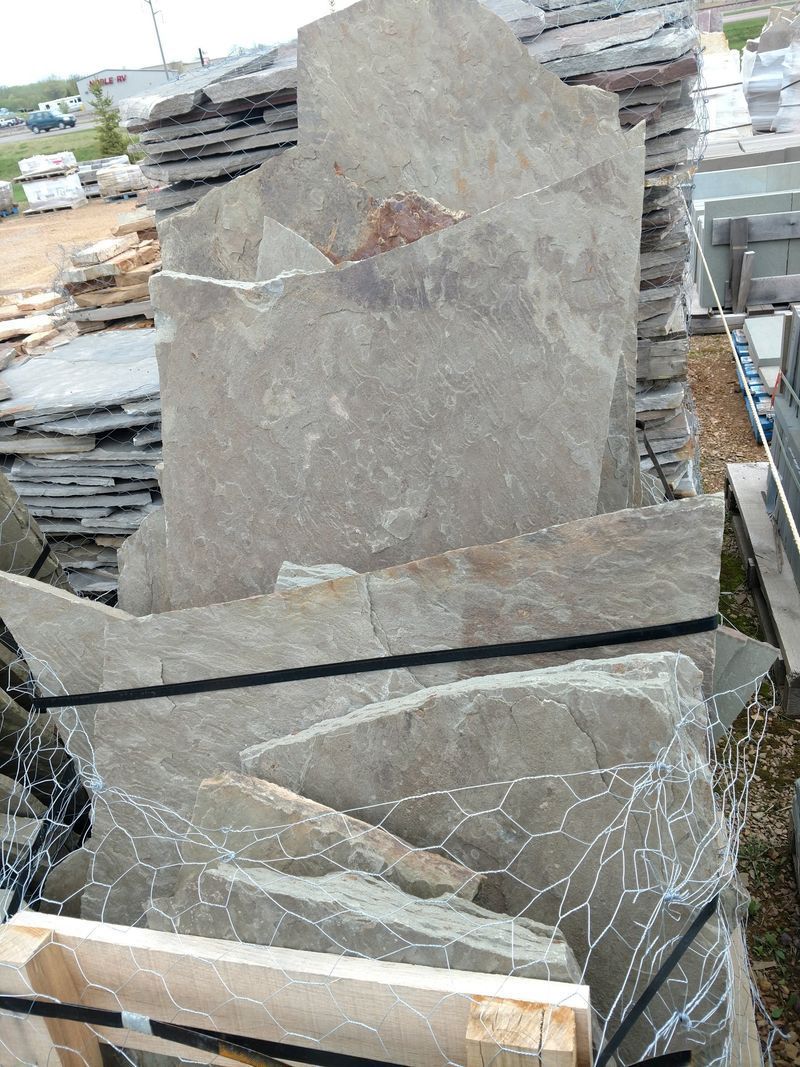 A pile of rocks stacked on top of each other in a yard.