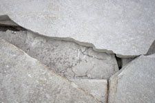 A close up of a cracked concrete wall.