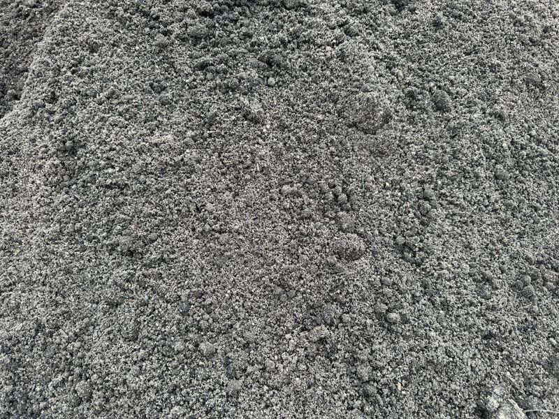 A pile of gravel is sitting on top of a pile of dirt.