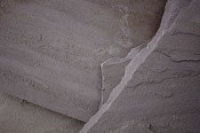 A close up of a piece of stone on a wall.