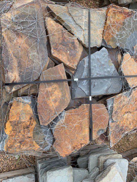 A pile of rocks is tied together with a black strap.