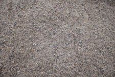 A pile of gravel is sitting on the ground.