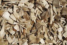 A pile of wood chips is sitting on the ground.