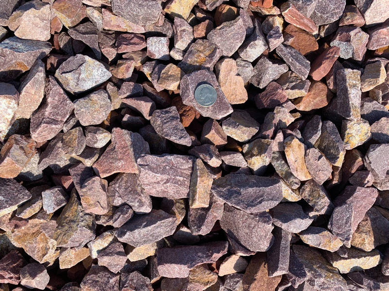 A pile of rocks with a coin in the middle.