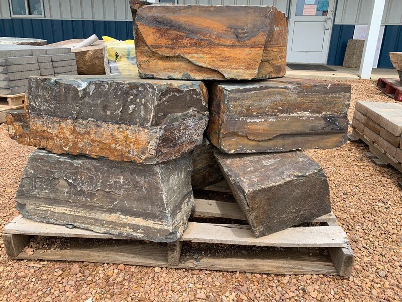 A pile of rocks stacked on top of each other on a wooden pallet.