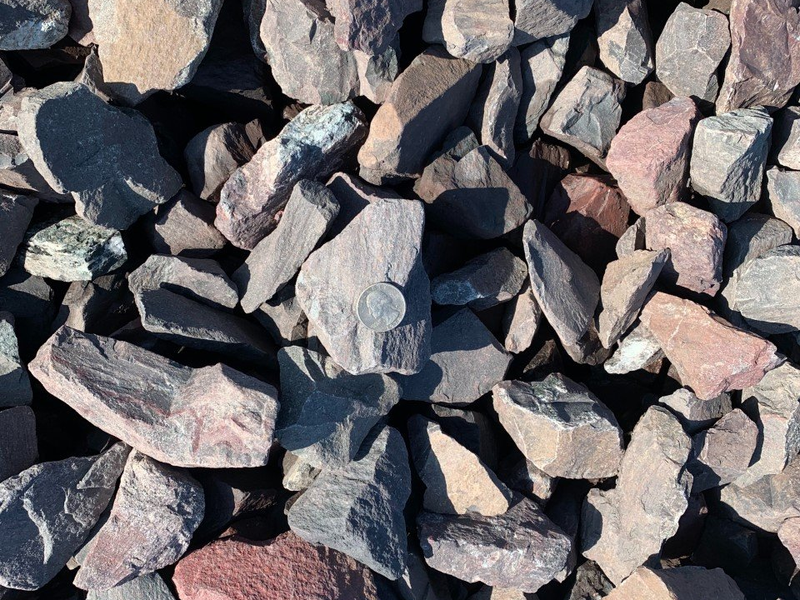 A pile of rocks with a coin in the middle