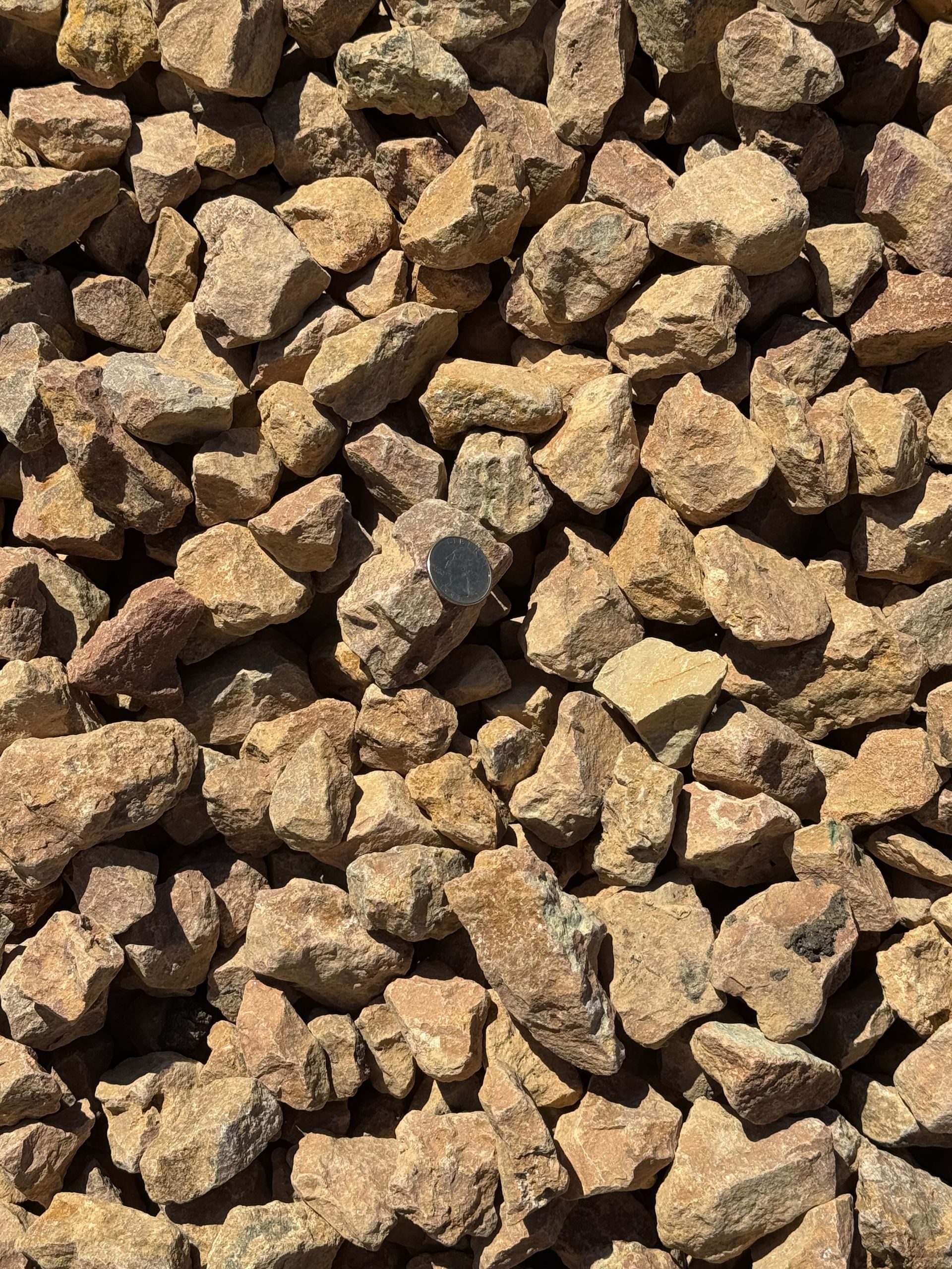 A pile of brown gravel is sitting on the ground.