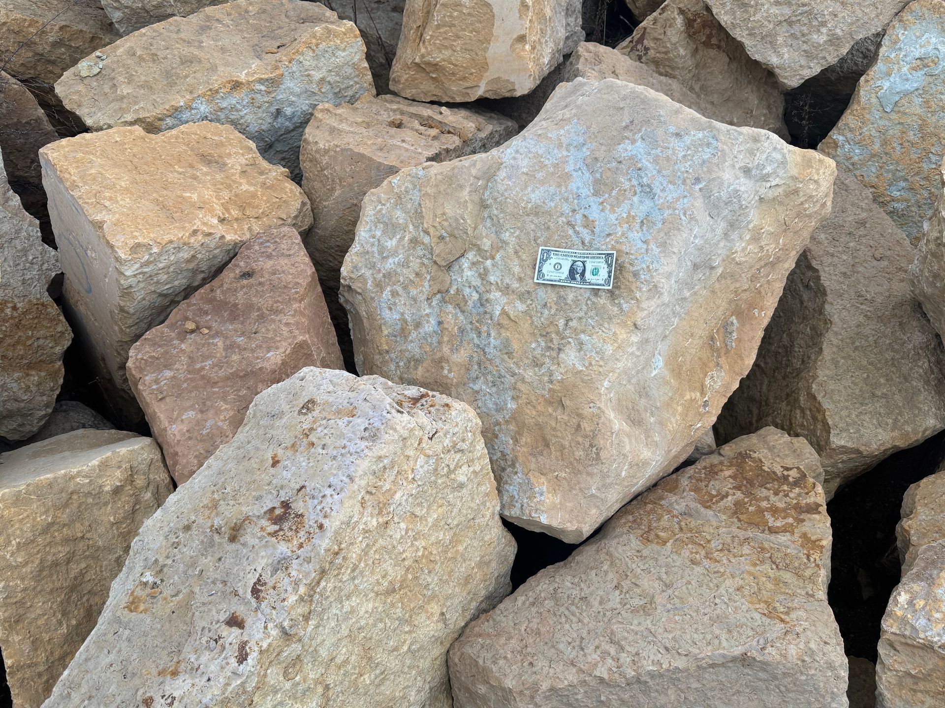 Two large rocks are sitting next to each other on the ground.