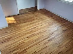A room with hardwood floors and a purple wall.