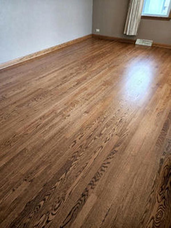 A living room with hardwood floors and a window.