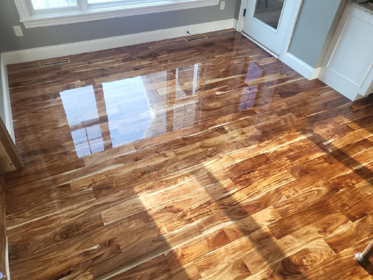 A room with a wooden floor and a window