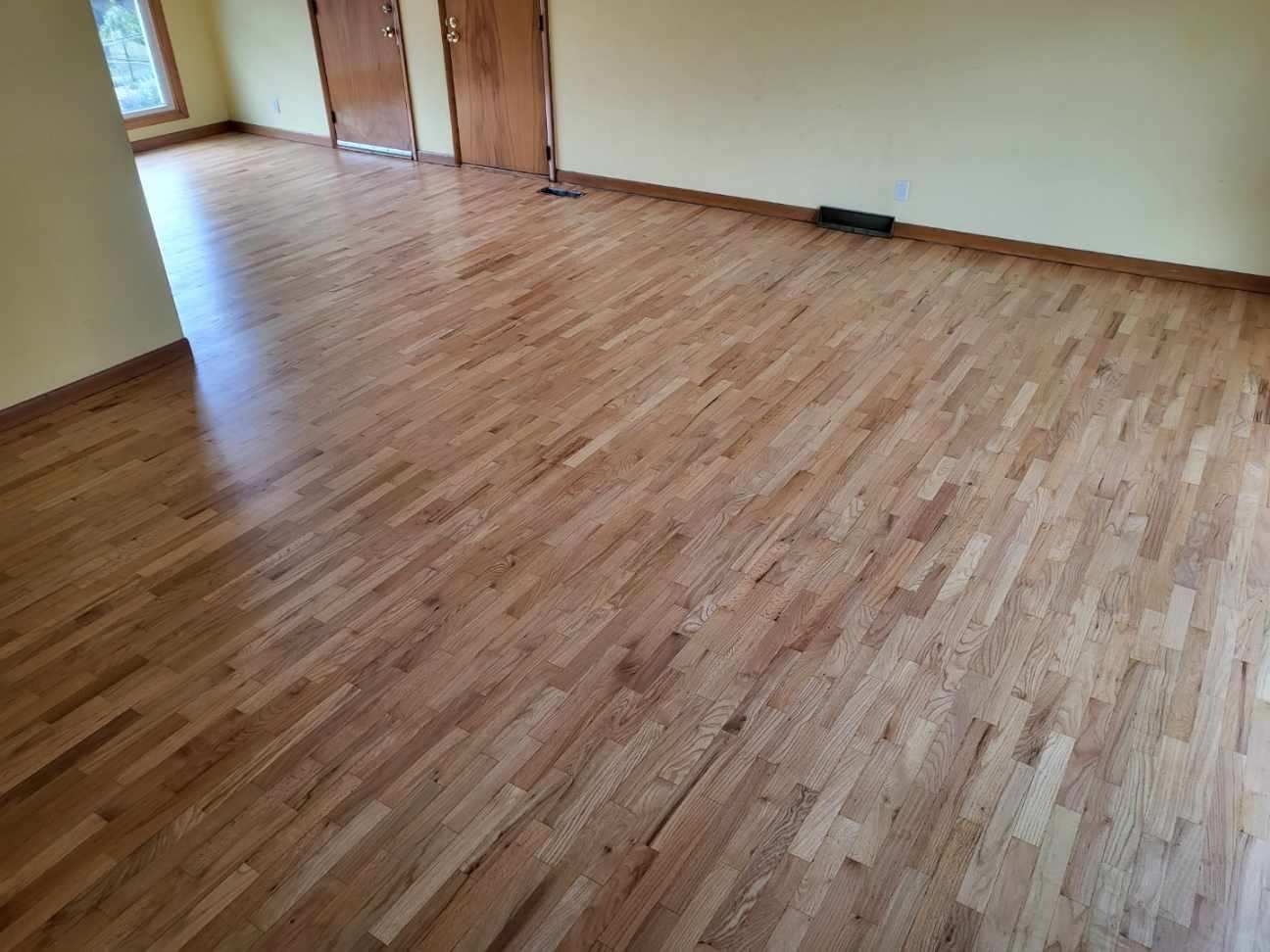 A living room with a wooden floor