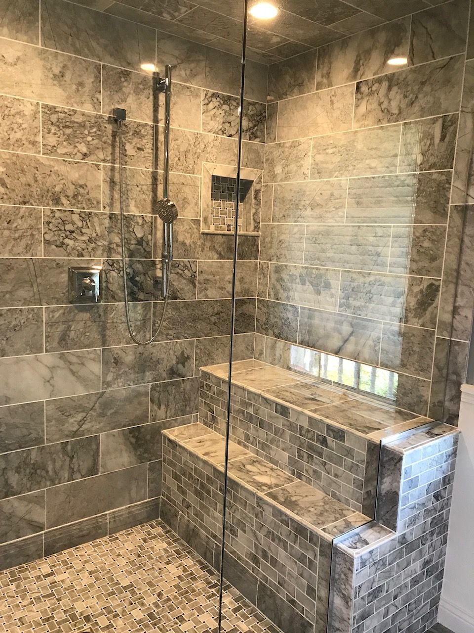 A bathroom with a walk in shower