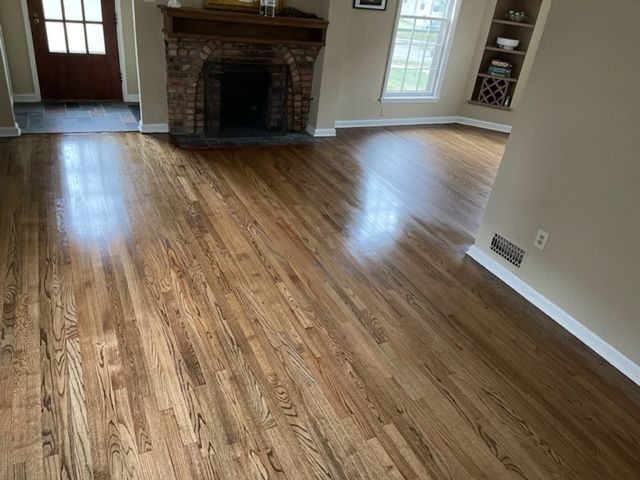 A living room with hardwood floors and a fireplace