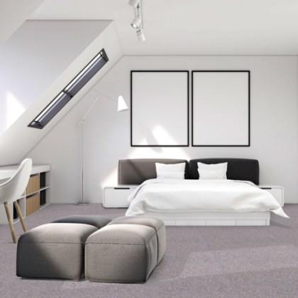 A bedroom with a large bed and two ottomans