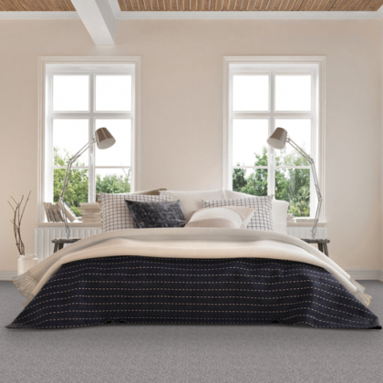 A bedroom with a bed , two lamps and two windows.