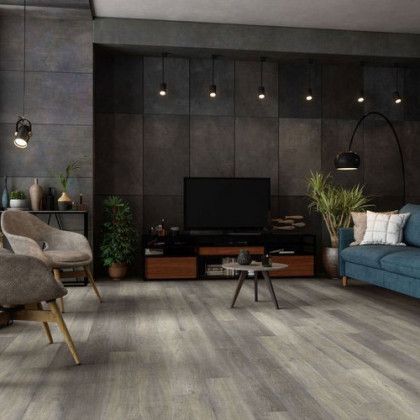 A living room with a couch , chairs , table and television.