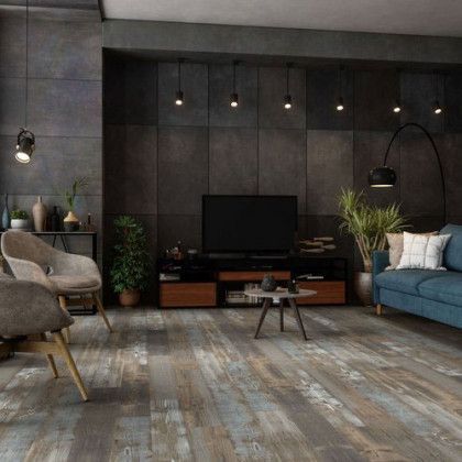 A living room with a couch , chairs , and a television.
