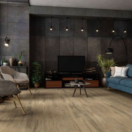 A living room with a couch , chairs , and a television.