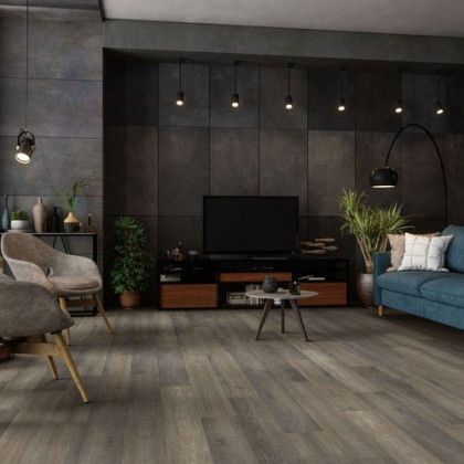 A living room with a couch , chairs , and a television.