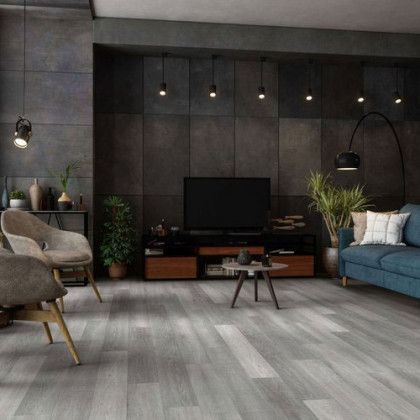 A living room with a couch , chairs , and a television.
