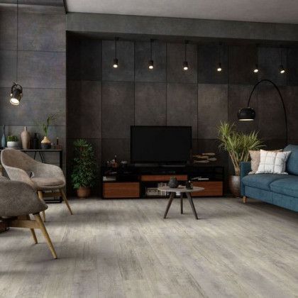 A living room with a couch , chairs , and a television.