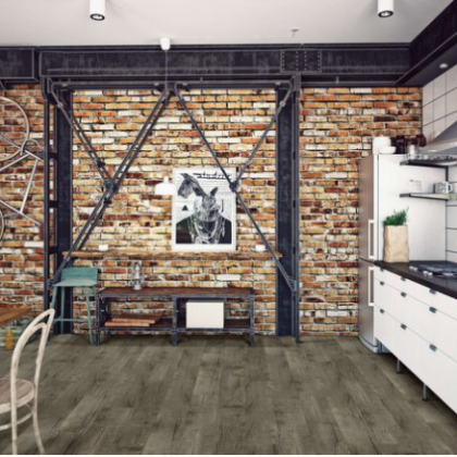 A kitchen with a brick wall and a picture of a rabbit on the wall