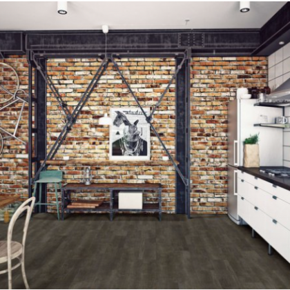 A kitchen with a brick wall and a picture on the wall