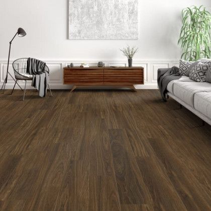 A living room with hardwood floors and a couch and chair.