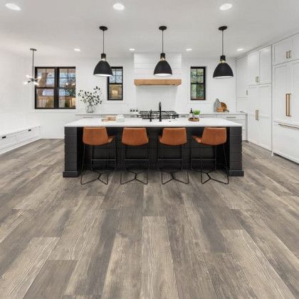 A kitchen with hardwood floors and a large island.