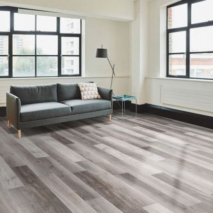 A living room with hardwood floors and a couch.