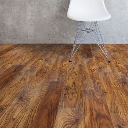 A white chair is sitting on a wooden floor.