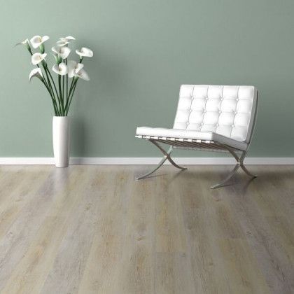 There is a chair and a vase of flowers in the room.