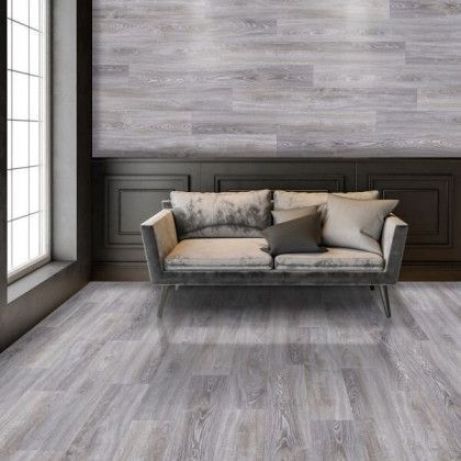 A living room with a couch and a wooden floor.