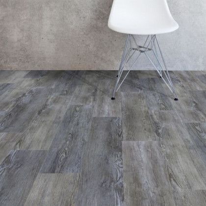 A white chair is sitting on a wooden floor in a room.