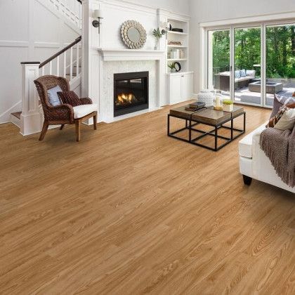 A living room with hardwood floors and a fireplace.