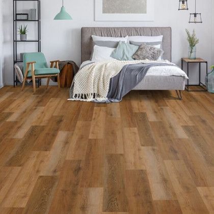 A bedroom with hardwood floors and a bed.