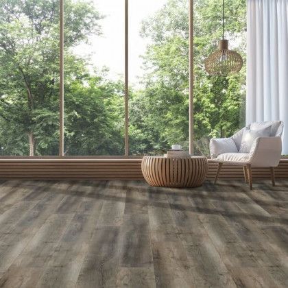 A living room with hardwood floors , a chair , a table and a large window.