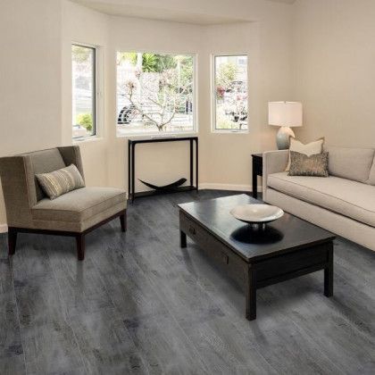 A living room with a couch , chairs , and a coffee table.