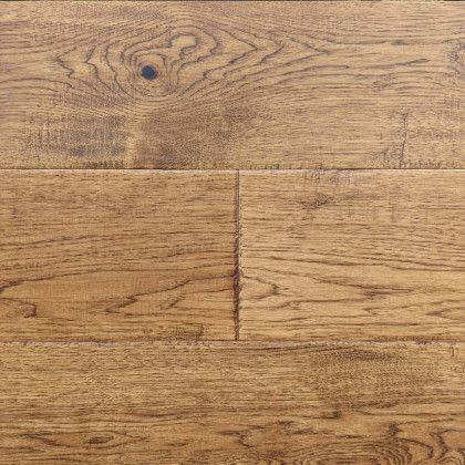 A close up of a wooden floor with a hole in it.