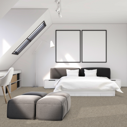 A bedroom with a large bed and two ottomans