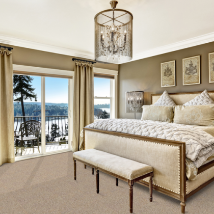 A bedroom with a large bed and a bench